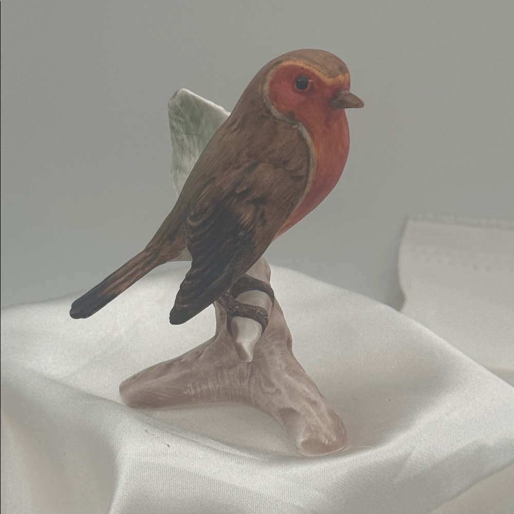 A vintage porcelain Robin figurine manufactured by Goebel in West Germany.